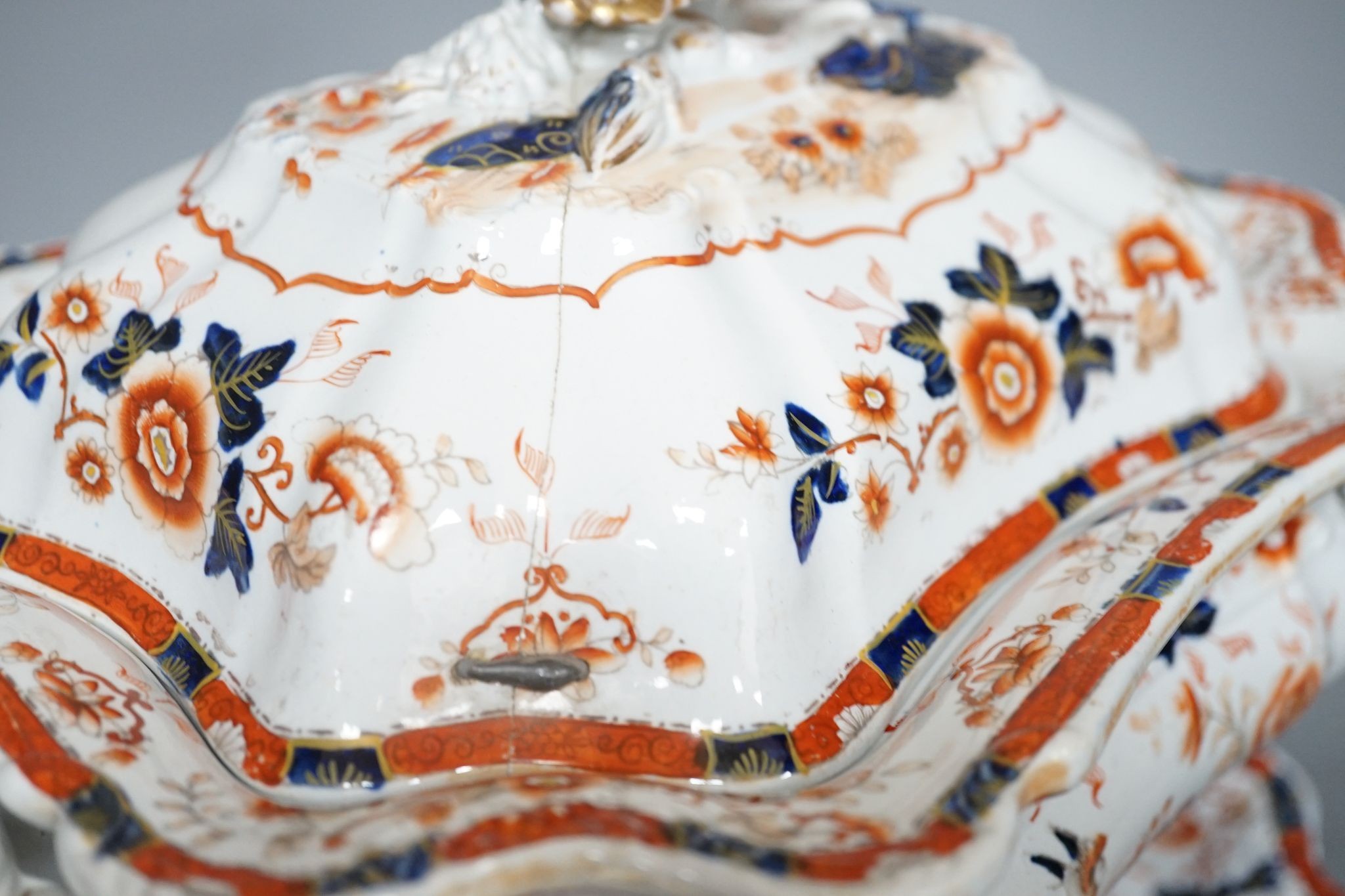 An early 19th century stoneware soup tureen and cover on stand, decorated in cobalt blue and iron red, a similar tureen, a pair of small covered dishes, Staffordshire spaniels, etc.